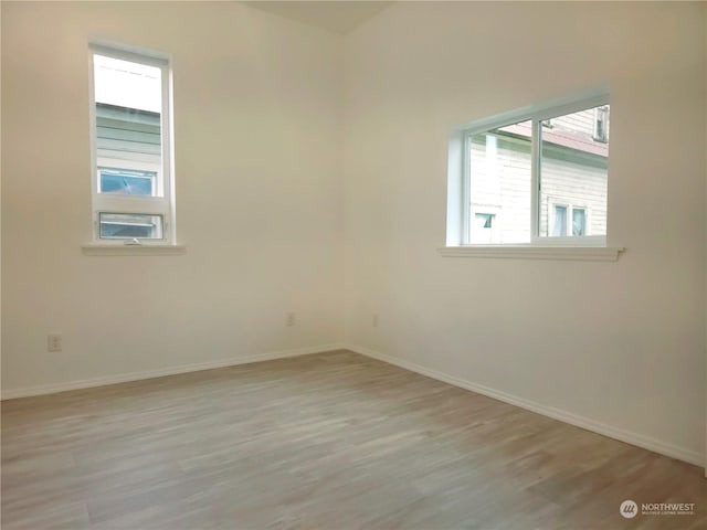 empty room with light hardwood / wood-style floors