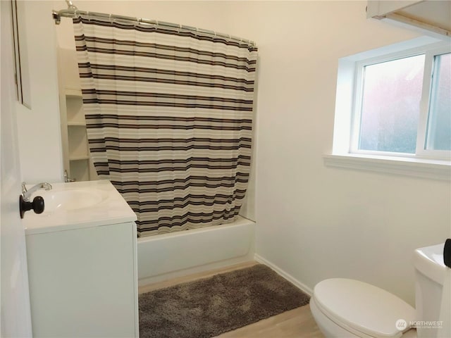 full bathroom featuring shower / bath combo, toilet, and vanity