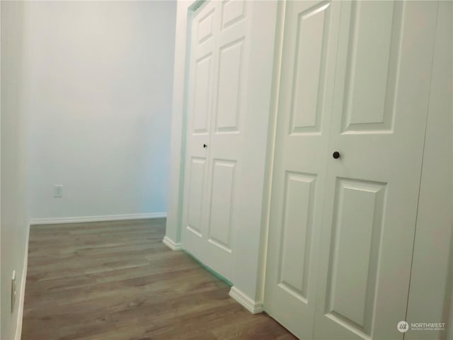 corridor with light hardwood / wood-style flooring