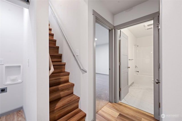 stairway with hardwood / wood-style floors