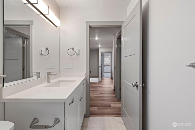 bathroom with vanity and hardwood / wood-style flooring