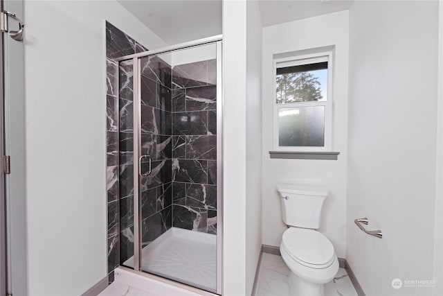 bathroom with toilet and a shower with shower door