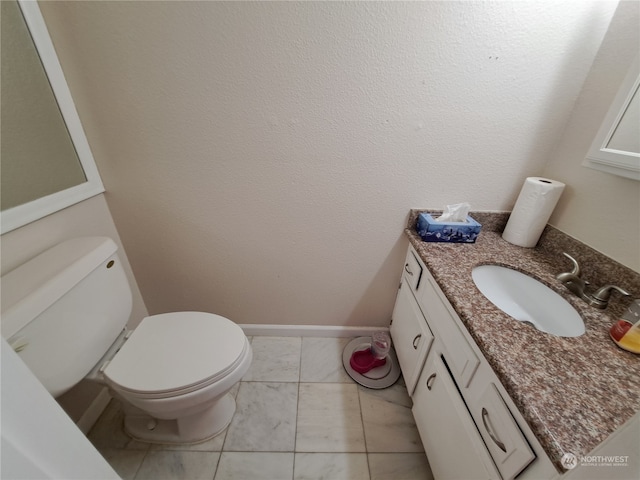 bathroom with vanity, toilet, and tile patterned flooring