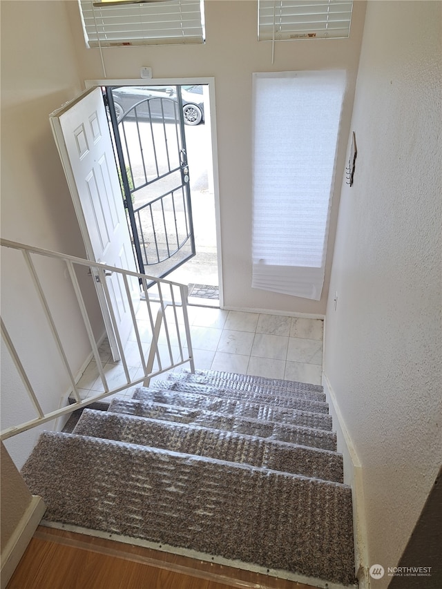 staircase featuring tile patterned floors