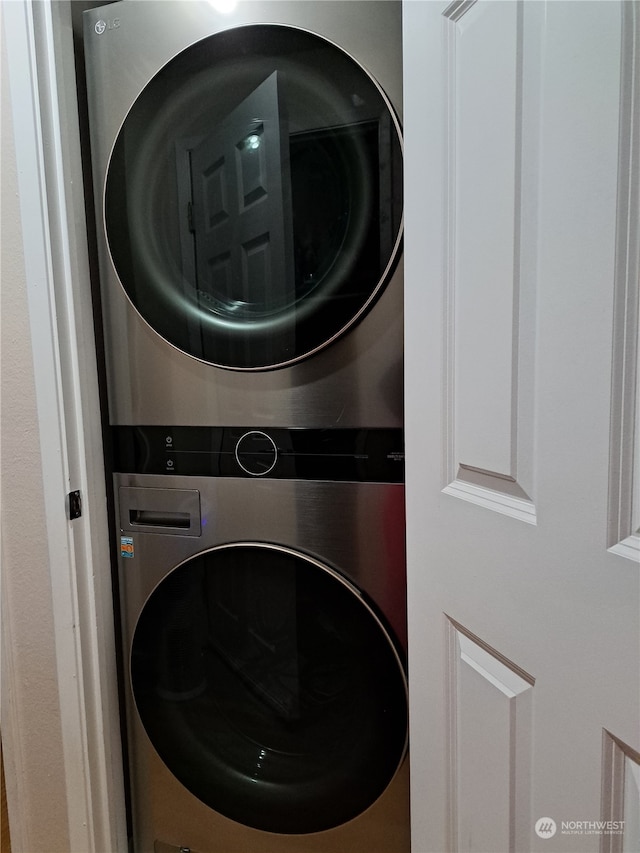 washroom with stacked washer and dryer