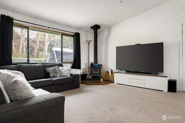 living room with carpet flooring and a wood stove