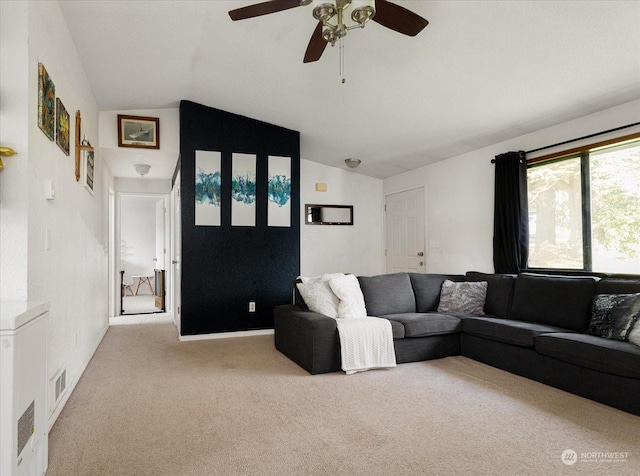 living room with light carpet, vaulted ceiling, and ceiling fan