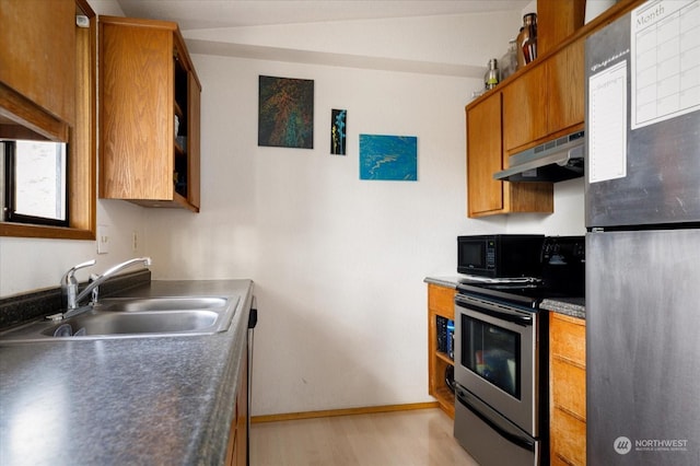 kitchen with stainless steel appliances, light hardwood / wood-style floors, and sink