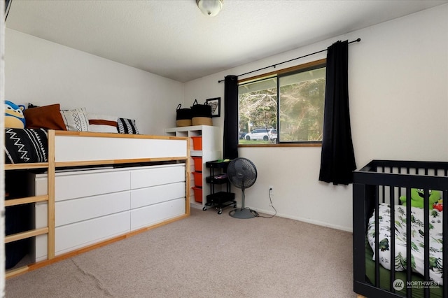 bedroom featuring light colored carpet and a crib