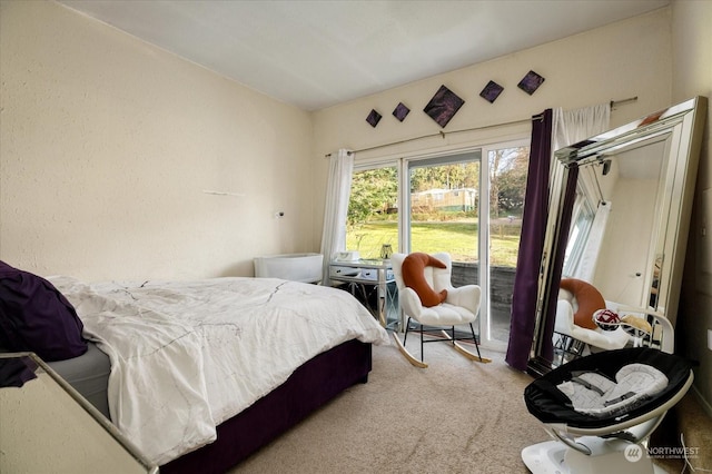 carpeted bedroom with access to outside