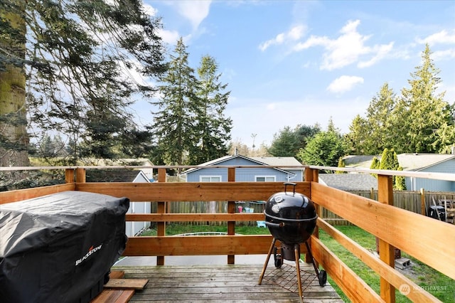 wooden terrace featuring a grill