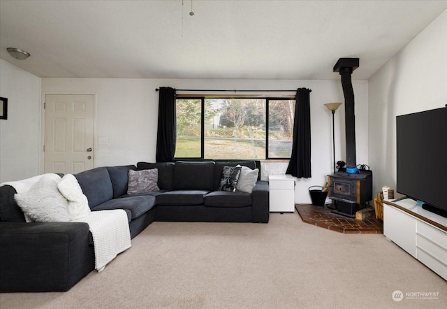 living room with a wood stove and carpet floors