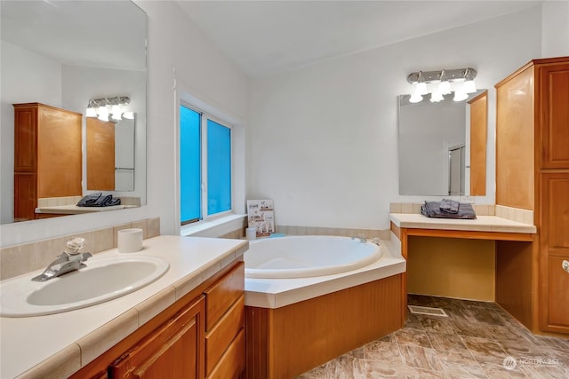 bathroom with vanity and a tub