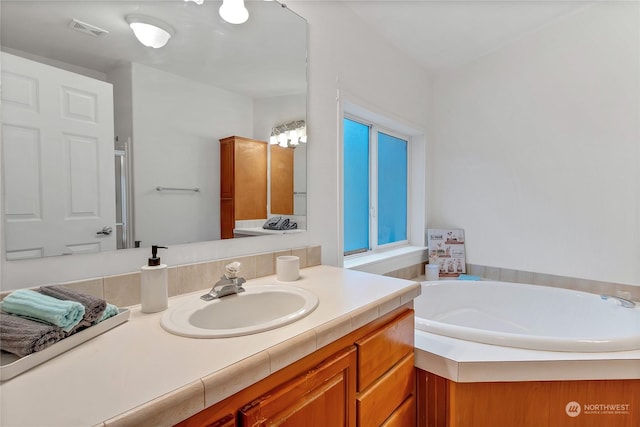 bathroom featuring a tub to relax in and vanity