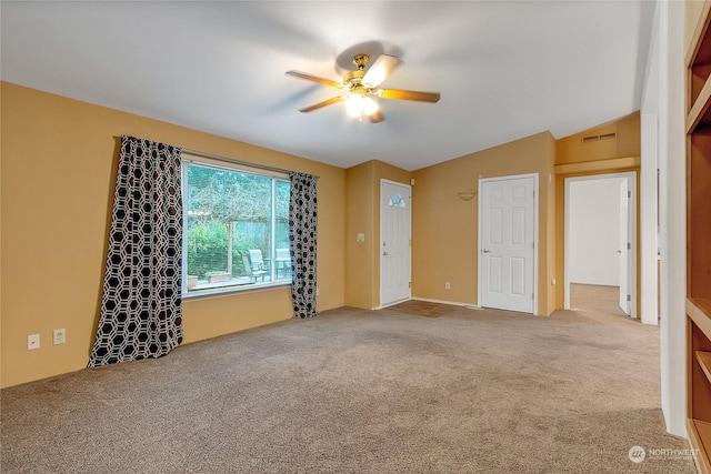 unfurnished room featuring carpet flooring, ceiling fan, and vaulted ceiling