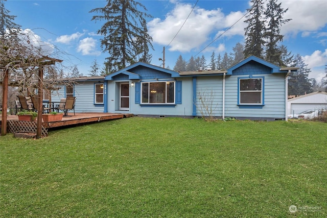 rear view of property featuring a yard and a deck