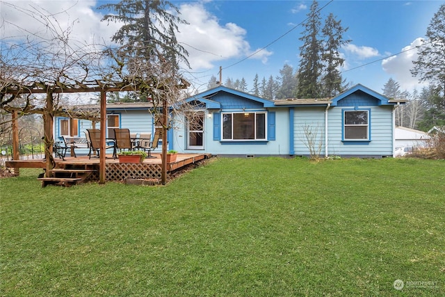 rear view of house featuring a deck and a yard