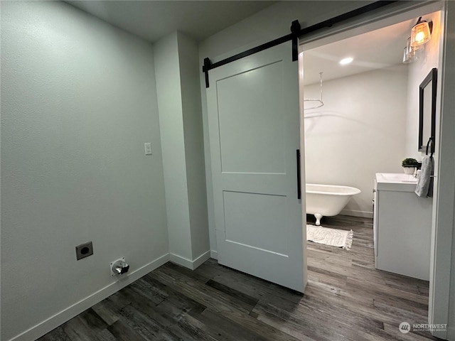 bathroom with a bathtub, vanity, and hardwood / wood-style flooring