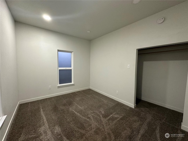 unfurnished bedroom featuring dark colored carpet