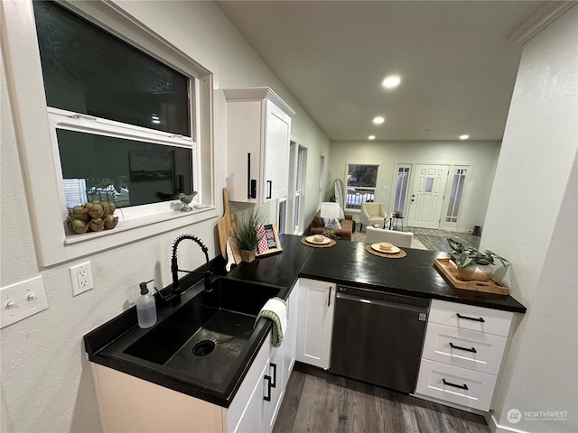 kitchen featuring dark hardwood / wood-style flooring, dishwasher, white cabinets, and sink