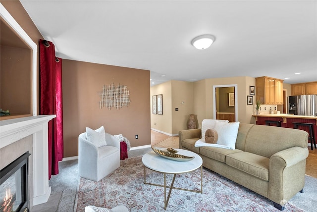 living room with light carpet and a premium fireplace