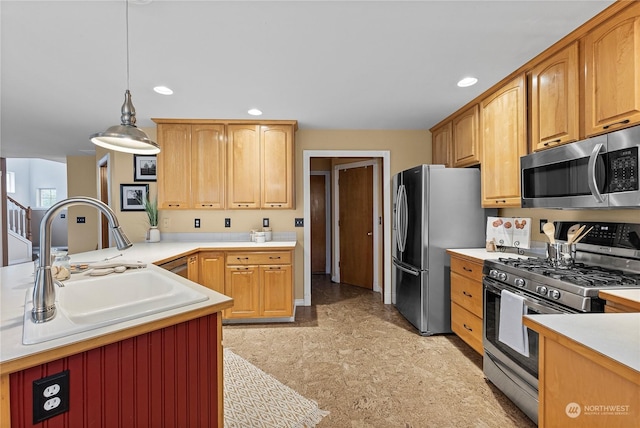 kitchen featuring decorative light fixtures, stainless steel appliances, and sink