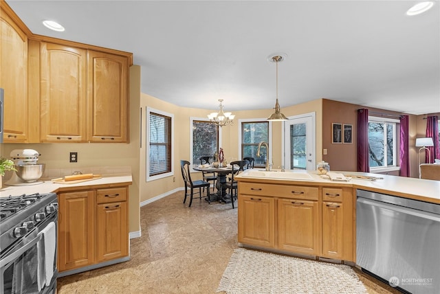 kitchen featuring pendant lighting, plenty of natural light, stainless steel appliances, and a notable chandelier