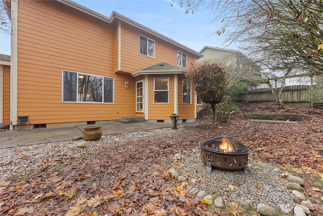 back of house with a fire pit