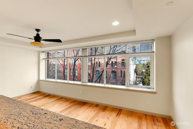 interior space with wood-type flooring and ceiling fan