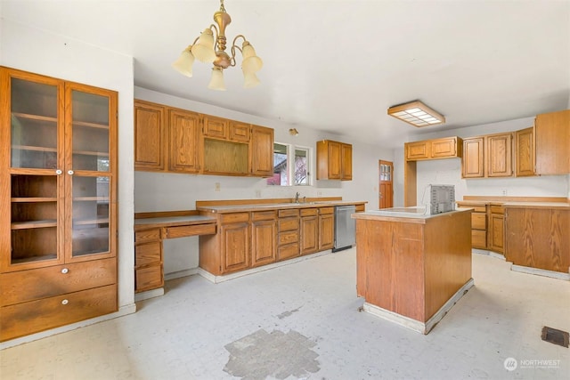 kitchen with dishwasher, sink, hanging light fixtures, a notable chandelier, and a kitchen island