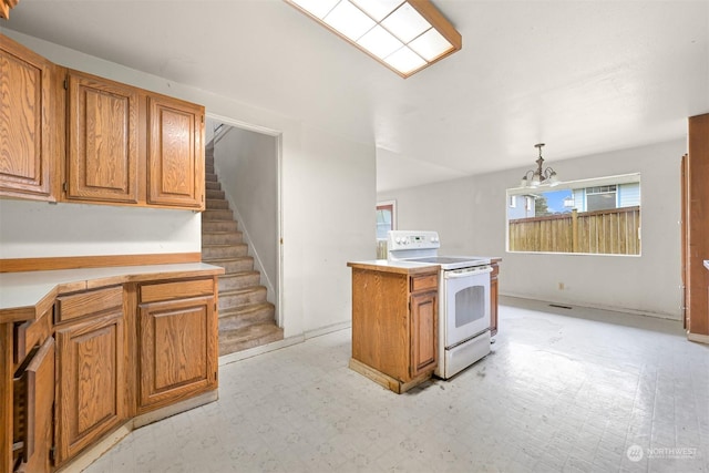 kitchen with pendant lighting, a center island, electric stove, and a chandelier