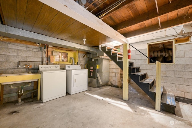 basement with washing machine and clothes dryer, heating unit, sink, and wooden ceiling