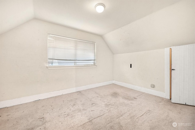 bonus room featuring light colored carpet and lofted ceiling