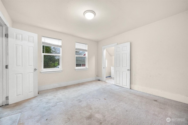 unfurnished bedroom featuring light carpet