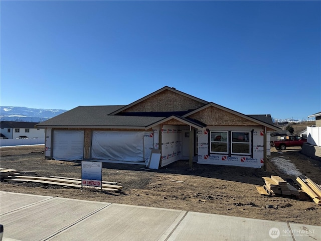 property under construction with a garage and a mountain view