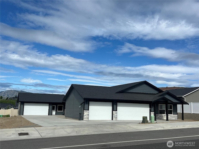 898 N Nile Ave, East Wenatchee, WA 98802 - view of front facade featuring an attached garage, stone siding, driveway, and a mountain view