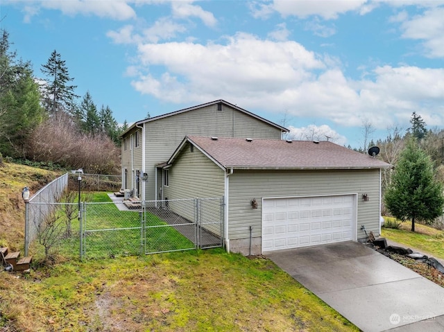 view of side of property featuring a garage and a yard