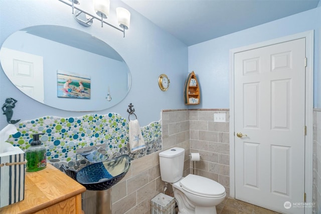 bathroom with tile walls and toilet