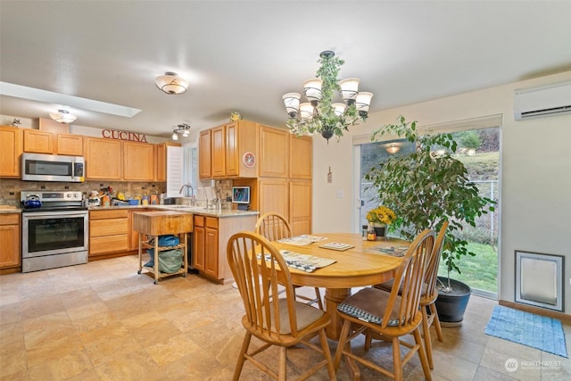 dining room with an AC wall unit, sink, an inviting chandelier, and a skylight