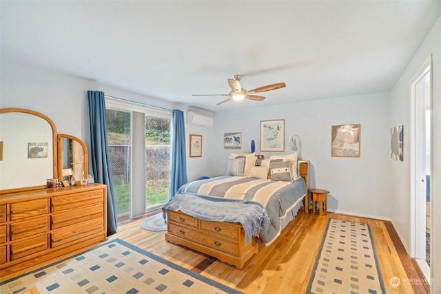 bedroom with access to outside, a wall mounted AC, ceiling fan, and light hardwood / wood-style flooring