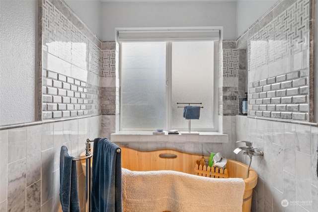 bathroom with tile walls