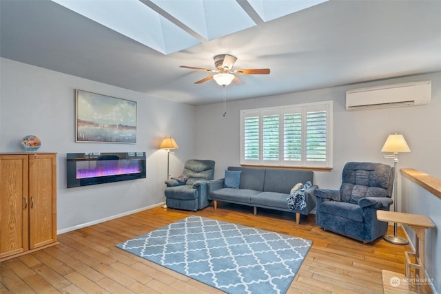 living room with ceiling fan, light hardwood / wood-style floors, a wall unit AC, and a skylight