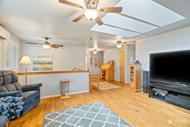 living room with hardwood / wood-style floors and a skylight