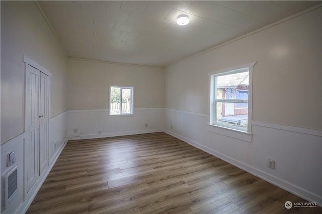 spare room featuring hardwood / wood-style flooring and crown molding