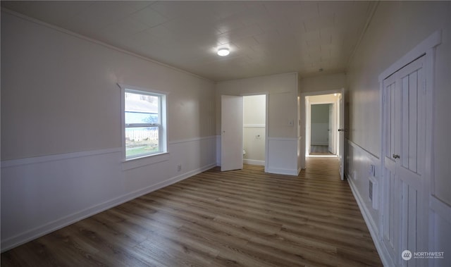 unfurnished bedroom with dark hardwood / wood-style floors