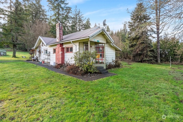 view of side of property featuring a yard