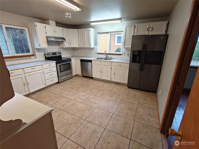 kitchen with white cabinetry, sink, light tile patterned floors, and stainless steel appliances