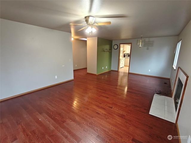 unfurnished living room with hardwood / wood-style floors and ceiling fan with notable chandelier