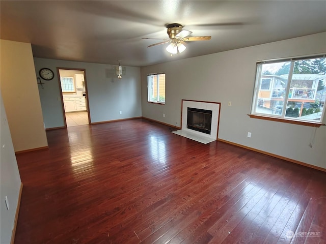 unfurnished living room with ceiling fan and wood-type flooring