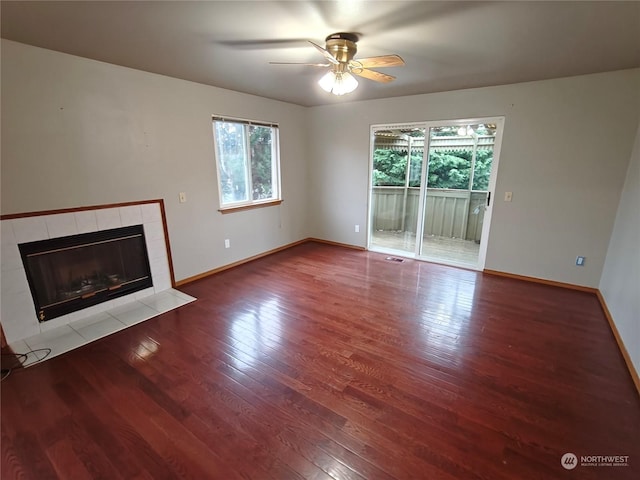 unfurnished living room featuring a fireplace, hardwood / wood-style floors, and ceiling fan